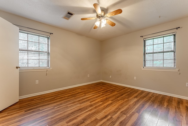1655 Doe Trl, Conway, AR 72034 - unfurnished room with wood finished floors, ceiling fan, baseboards, and a textured ceiling