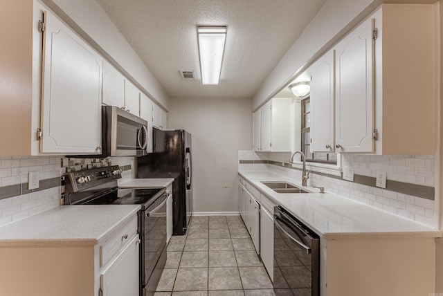 1655 Doe Trl, Conway, AR 72034 - kitchen with appliances with stainless steel finishes, a sink, white cabinets, and a textured ceiling