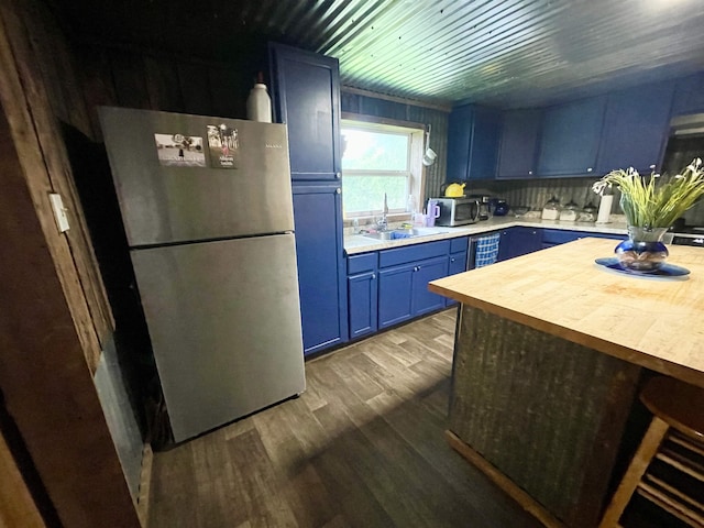 11 Fruitwood Ln, Glencoe, AR 72539 - kitchen featuring appliances with stainless steel finishes, blue cabinetry, a sink, butcher block counters, and dark wood-type flooring