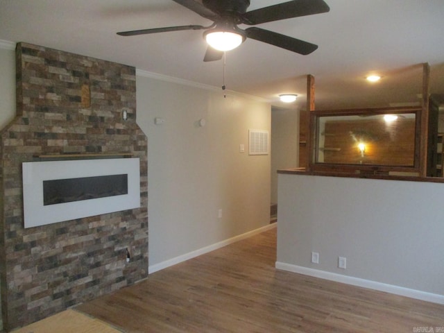 13 Cevico Ln, Hot Springs Village, AR 71909 - unfurnished living room featuring wood finished floors, a ceiling fan, crown molding, baseboards, and a fireplace