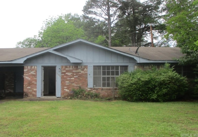 3908 S Hazel St, Pine Bluff, AR 71603 - single story home featuring brick siding, a front yard, and board and batten siding