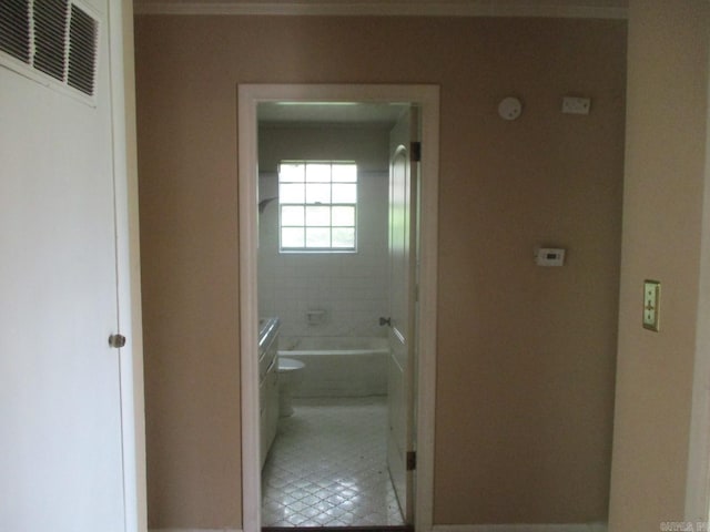 3908 S Hazel St, Pine Bluff, AR 71603 - bathroom with crown molding, toilet, tile patterned flooring, and baseboards