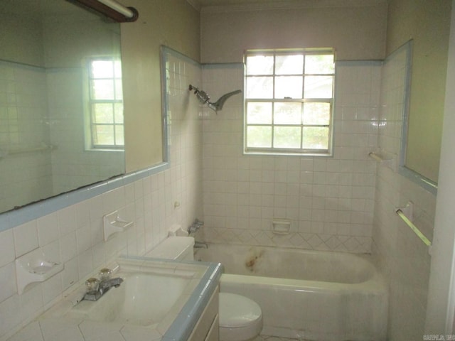 3908 S Hazel St, Pine Bluff, AR 71603 - full bathroom featuring toilet,  shower combination, tile walls, and vanity