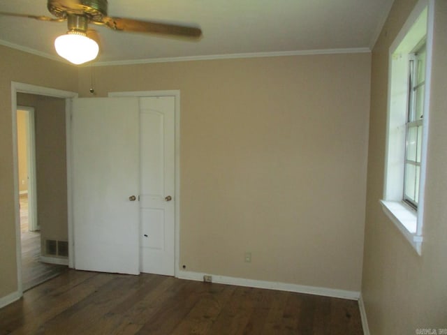 3908 S Hazel St, Pine Bluff, AR 71603 - unfurnished bedroom with ornamental molding, wood finished floors, a closet, baseboards, and ceiling fan