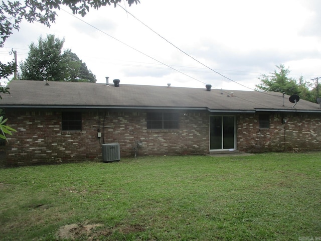 3908 S Hazel St, Pine Bluff, AR 71603 - rear view of property with a yard, brick siding, and central AC
