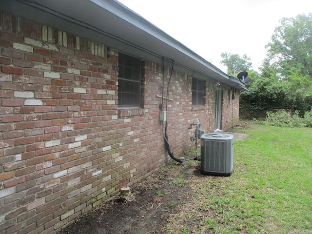 3908 S Hazel St, Pine Bluff, AR 71603 - view of property exterior with cooling unit, a yard, and brick siding
