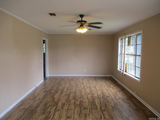 3908 S Hazel St, Pine Bluff, AR 71603 - unfurnished room featuring dark wood-style flooring, a ceiling fan, baseboards, and crown molding