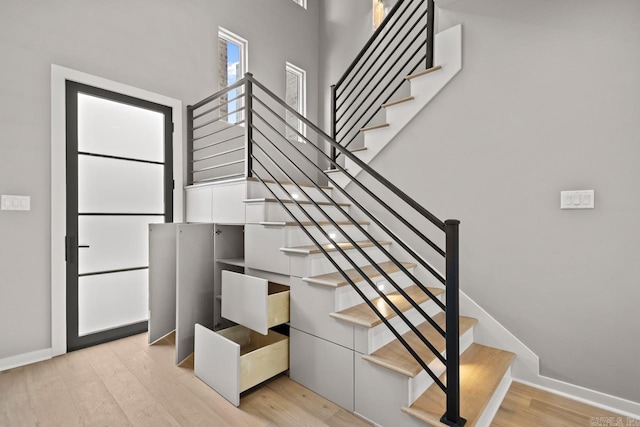 22 Abington Ct, Little Rock, AR 72223 - staircase with wood finished floors, baseboards, and a high ceiling