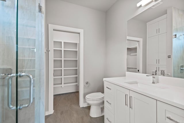 22 Abington Ct, Little Rock, AR 72223 - bathroom featuring a spacious closet, vanity, a stall shower, and toilet