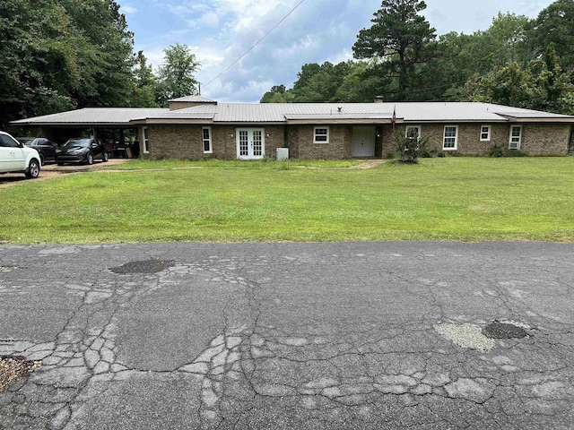 1240 Moses St, Camden, AR 71701 - ranch-style home with a front yard, metal roof, a chimney, and brick siding