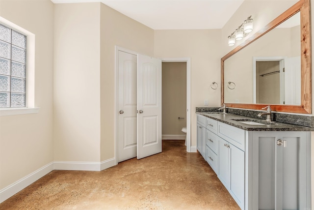 2820 Zion St, Little Rock, AR 72204 - bathroom with baseboards, double vanity, toilet, and finished concrete floors