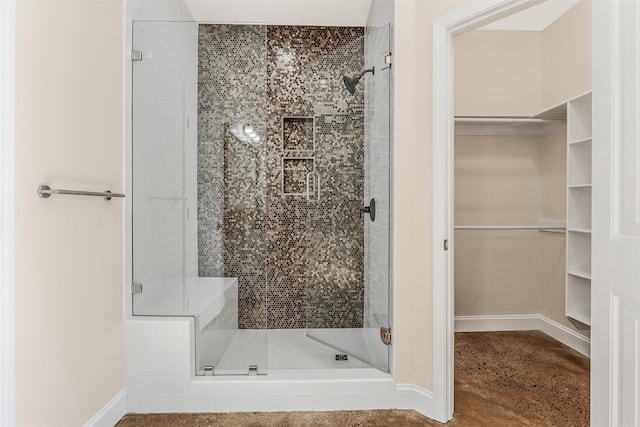 2820 Zion St, Little Rock, AR 72204 - full bathroom with a shower stall, a walk in closet, and baseboards