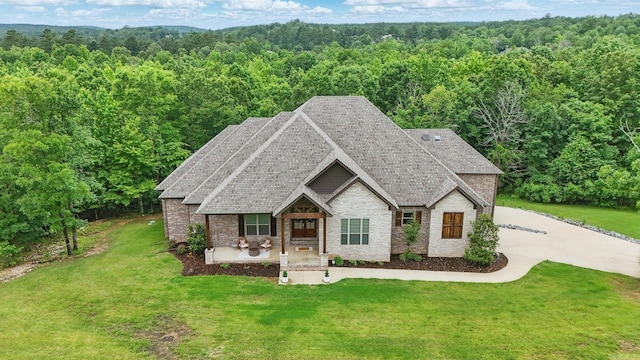 1045 Boulder Dr, Little Rock, AR 72210 - view of front of property featuring a wooded view, brick siding, and a front lawn