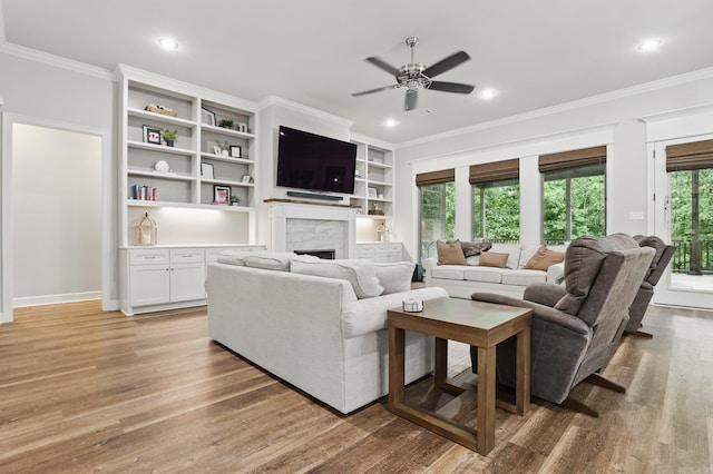 1045 Boulder Dr, Little Rock, AR 72210 - living room featuring crown molding, a ceiling fan, a fireplace, light wood-type flooring, and recessed lighting