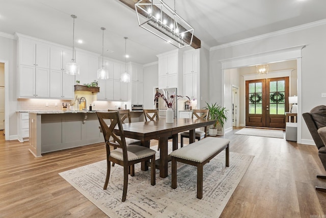 1045 Boulder Dr, Little Rock, AR 72210 - dining space featuring ornamental molding, french doors, light wood-style flooring, a chandelier, and recessed lighting
