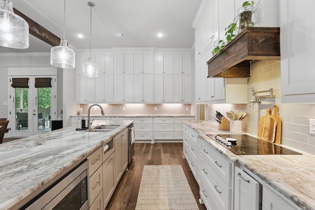 1045 Boulder Dr, Little Rock, AR 72210 - kitchen featuring a sink, stainless steel appliances, dark wood finished floors, decorative light fixtures, and white cabinetry