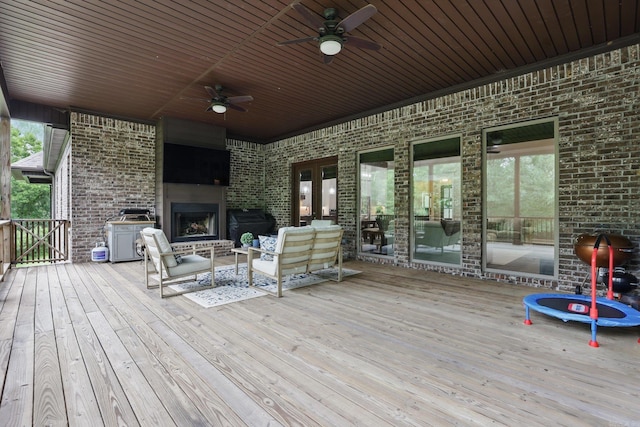 1045 Boulder Dr, Little Rock, AR 72210 - wooden deck featuring ceiling fan and an outdoor living space with a fireplace