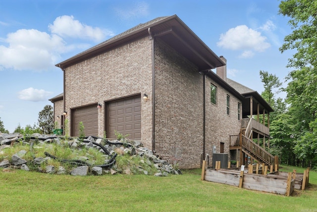 1045 Boulder Dr, Little Rock, AR 72210 - view of home's exterior featuring brick siding, a garage, stairs, central AC, and a chimney