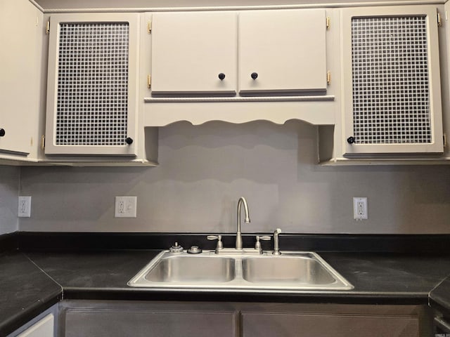 2715 Greenbriar Dr Apt B, Jonesboro, AR 72401 - kitchen featuring a sink, dark countertops, and white cabinetry