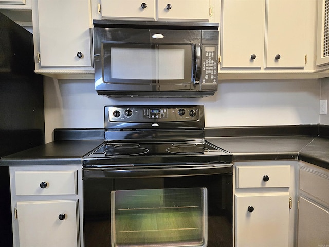 2715 Greenbriar Dr Apt B, Jonesboro, AR 72401 - kitchen featuring black appliances, dark countertops, and white cabinets
