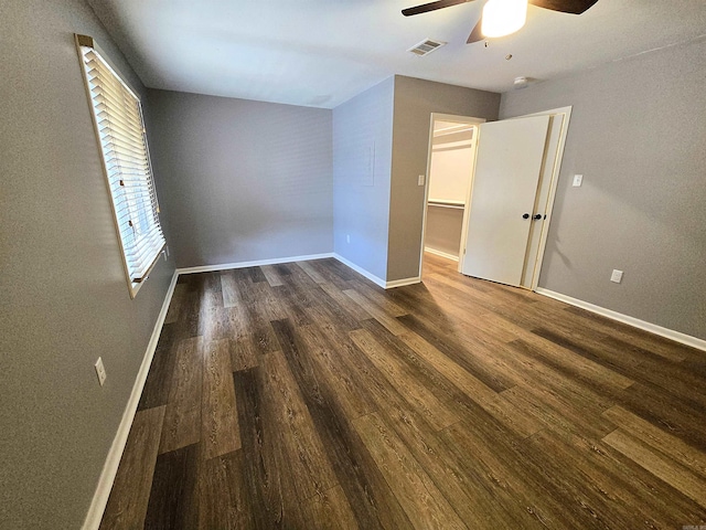 2715 Greenbriar Dr Apt B, Jonesboro, AR 72401 - unfurnished bedroom with dark wood-type flooring, baseboards, and ceiling fan
