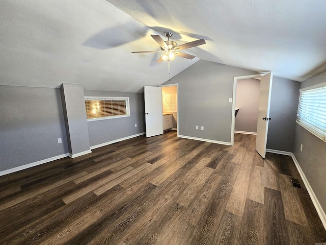 2715 Greenbriar Dr Apt B, Jonesboro, AR 72401 - unfurnished bedroom with dark wood-style floors, vaulted ceiling, a ceiling fan, a spacious closet, and baseboards