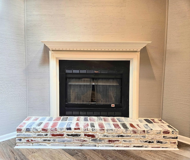 2715 Greenbriar Dr Apt B, Jonesboro, AR 72401 - detailed view of baseboards, a fireplace with raised hearth, and wood finished floors