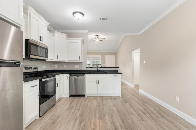 17 Woodhaven Dr, Cabot, AR 72023 - kitchen with stainless steel appliances, a ceiling fan, a peninsula, dark countertops, and white cabinets