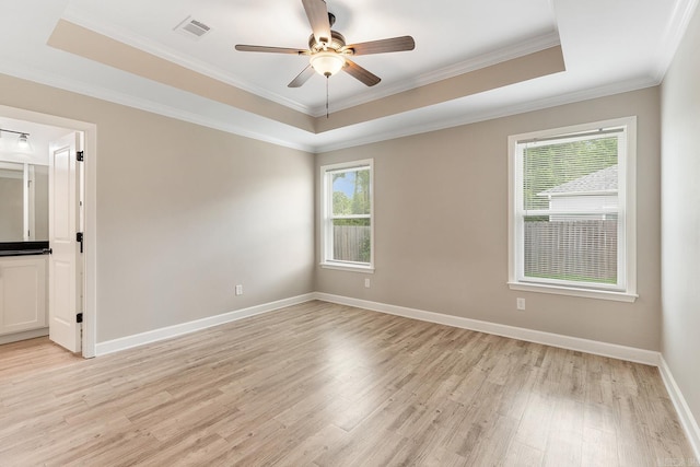 17 Woodhaven Dr, Cabot, AR 72023 - empty room with a raised ceiling, light wood finished floors, ceiling fan, crown molding, and baseboards