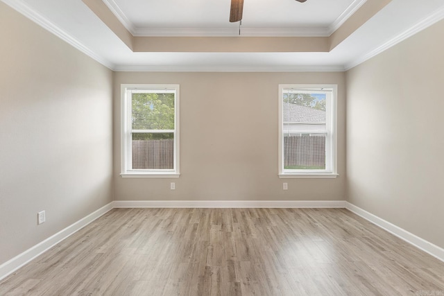 17 Woodhaven Dr, Cabot, AR 72023 - spare room featuring a tray ceiling, plenty of natural light, light wood-style flooring, and crown molding