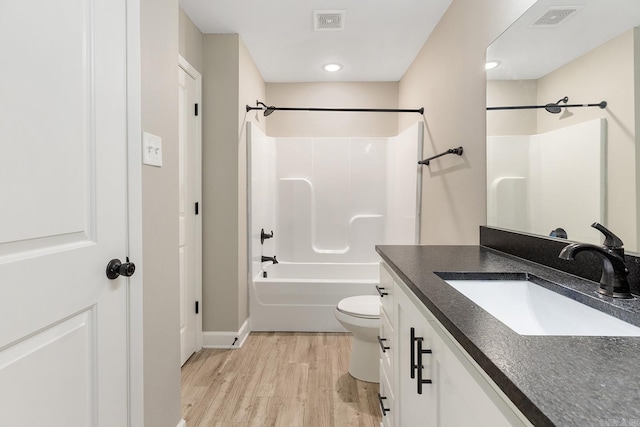 17 Woodhaven Dr, Cabot, AR 72023 - full bathroom featuring vanity, wood finished floors, baseboards, toilet, and shower / washtub combination