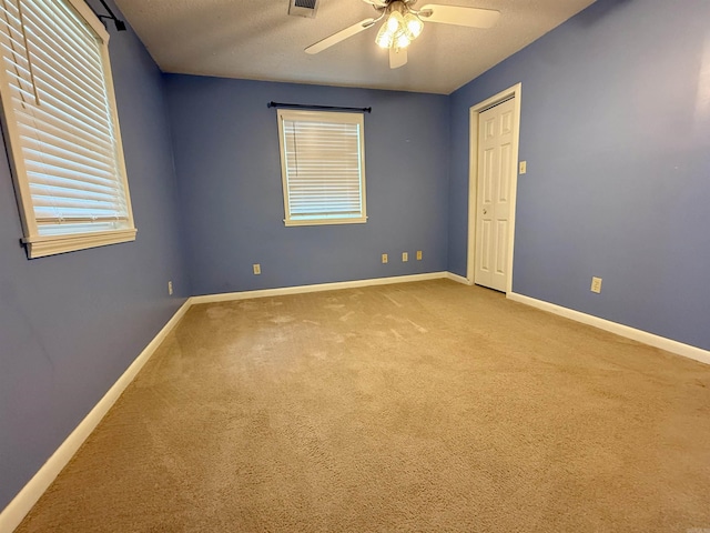 9925 Dublin Dr, Shannon Hills, AR 72103 - empty room with carpet floors, baseboards, ceiling fan, plenty of natural light, and a textured ceiling