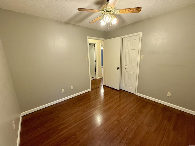 9925 Dublin Dr, Shannon Hills, AR 72103 - unfurnished room with dark wood-style floors, ceiling fan, baseboards, and a textured ceiling