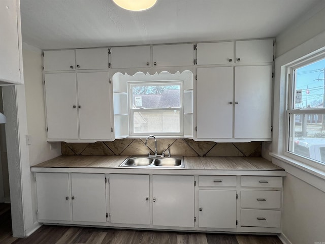 611 N Main St, Malvern, AR 72104 - kitchen featuring a sink, white cabinetry, dark wood-style floors, and tasteful backsplash