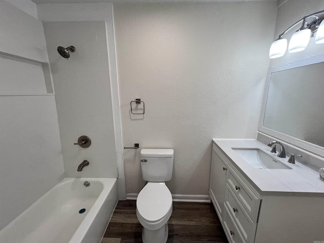 611 N Main St, Malvern, AR 72104 - full bathroom with wood finished floors, toilet, vanity, bathtub / shower combination, and baseboards