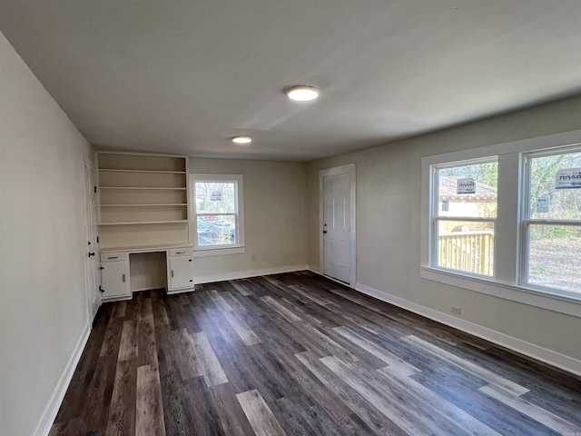 611 N Main St, Malvern, AR 72104 - unfurnished living room featuring dark wood-style floors and baseboards