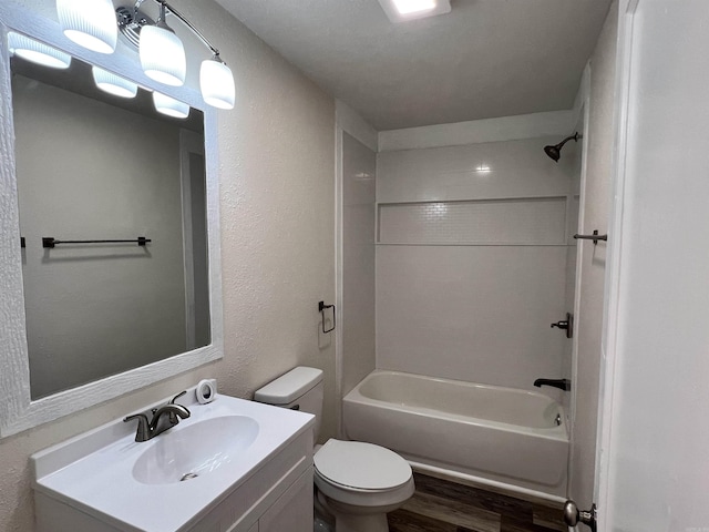 611 N Main St, Malvern, AR 72104 - bathroom featuring wood finished floors, vanity, toilet,  shower combination, and a textured wall