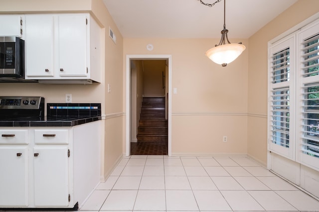 99 Kingsbridge Way, Little Rock, AR 72212 - kitchen featuring tile countertops, stainless steel appliances, white cabinetry, baseboards, and hanging light fixtures