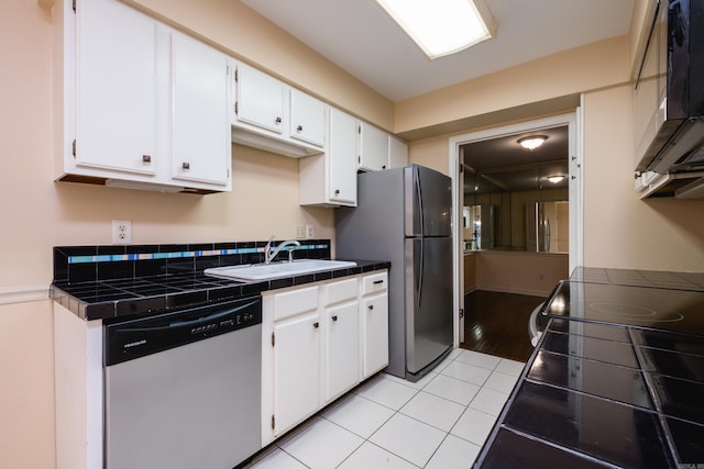 99 Kingsbridge Way, Little Rock, AR 72212 - kitchen with stainless steel appliances, a sink, tile countertops, and white cabinets