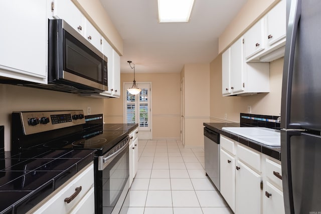 99 Kingsbridge Way, Little Rock, AR 72212 - kitchen featuring appliances with stainless steel finishes, tile counters, white cabinets, a sink, and light tile patterned flooring