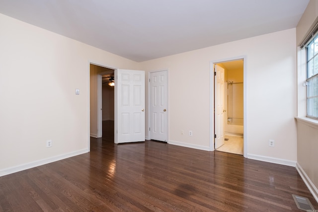 99 Kingsbridge Way, Little Rock, AR 72212 - unfurnished bedroom with wood finished floors, baseboards, and connected bathroom