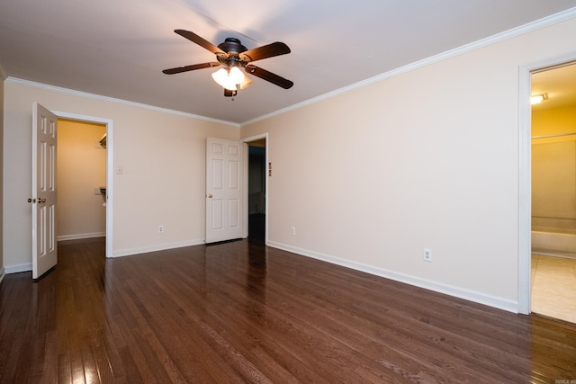 99 Kingsbridge Way, Little Rock, AR 72212 - unfurnished bedroom with crown molding, dark wood finished floors, a walk in closet, connected bathroom, and baseboards