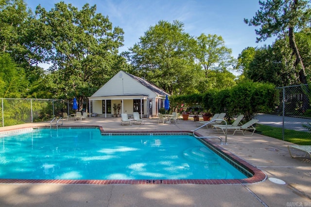 99 Kingsbridge Way, Little Rock, AR 72212 - community pool featuring a patio and view of scattered trees