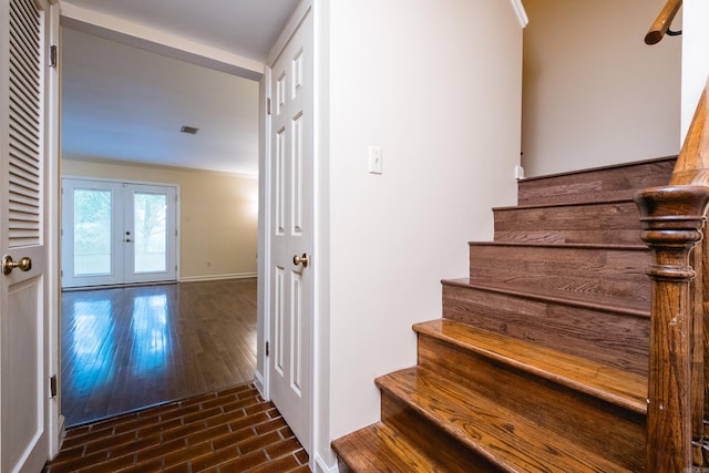 99 Kingsbridge Way, Little Rock, AR 72212 - staircase featuring french doors, wood finished floors, and baseboards