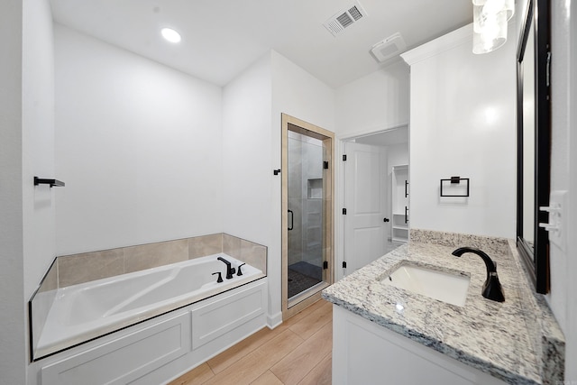 284 Shiloh, Beebe, AR 72102 - full bathroom with a shower stall, a garden tub, vanity, and wood finished floors