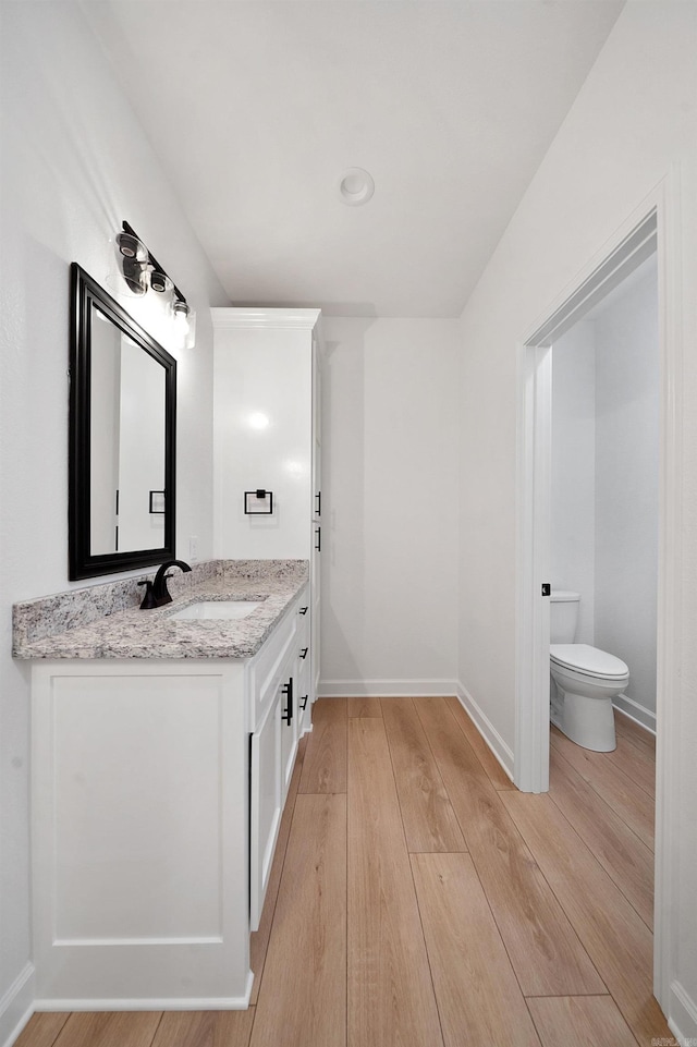 284 Shiloh, Beebe, AR 72102 - bathroom with double vanity, toilet, wood finished floors, and baseboards