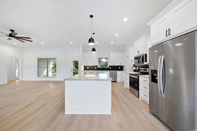 284 Shiloh, Beebe, AR 72102 - kitchen featuring appliances with stainless steel finishes, a kitchen island, plenty of natural light, white cabinetry, and recessed lighting
