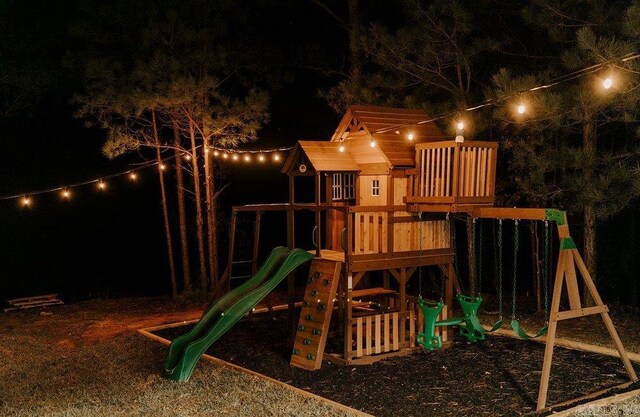 2441 Miller County 77, Doddridge, AR 71834 - playground at twilight featuring a playground