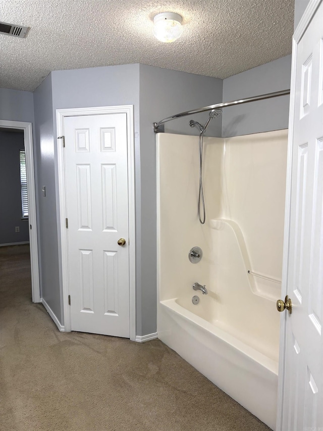 54 Redleaf Crk, Little Rock, AR 72210 - bathroom with a textured ceiling, tub / shower combination, baseboards, and carpet flooring
