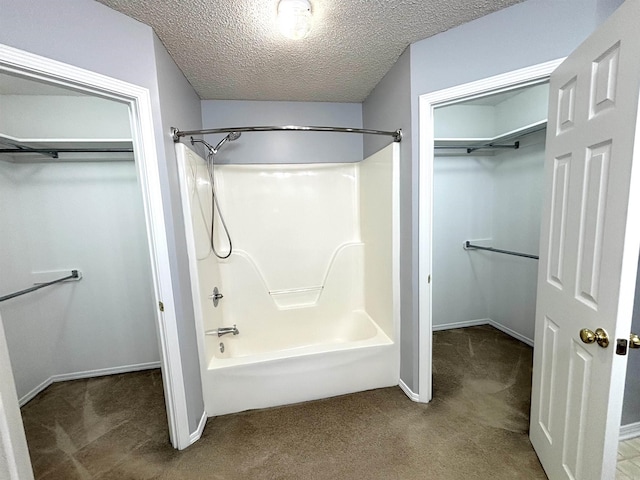 54 Redleaf Crk, Little Rock, AR 72210 - bathroom featuring bathing tub / shower combination, a walk in closet, baseboards, and a textured ceiling